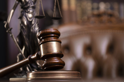 A gavel on a wooden desk.